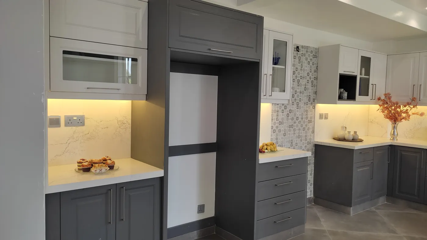 White and grey kitchen mid-renovation with island, Nairobi