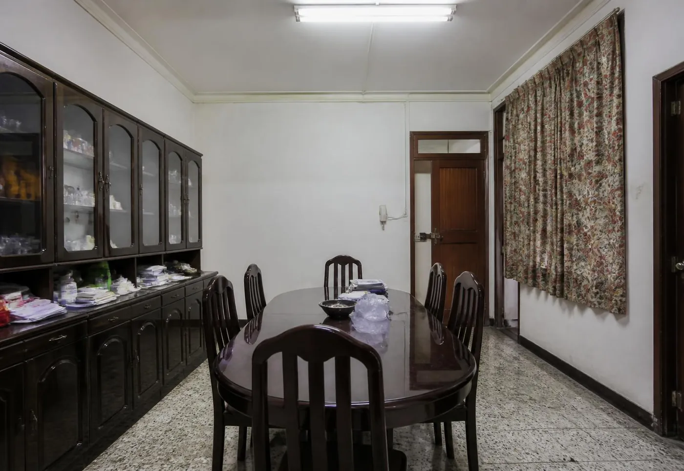 Dining room before the refresh, with dark furniture and plain walls