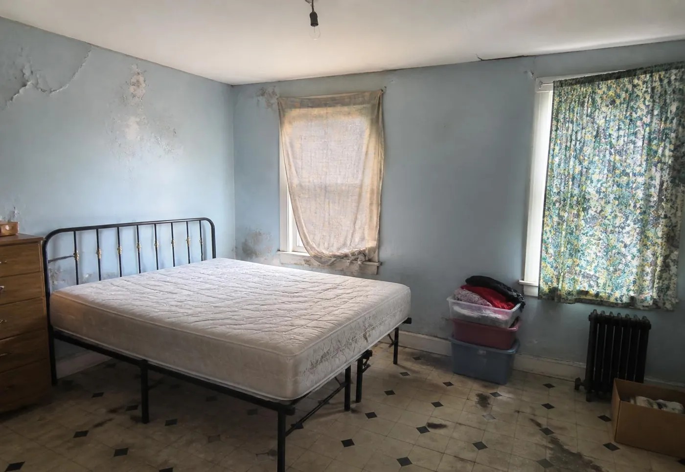 Before: bare master bedroom with metal bed and unfinished walls, Lavington