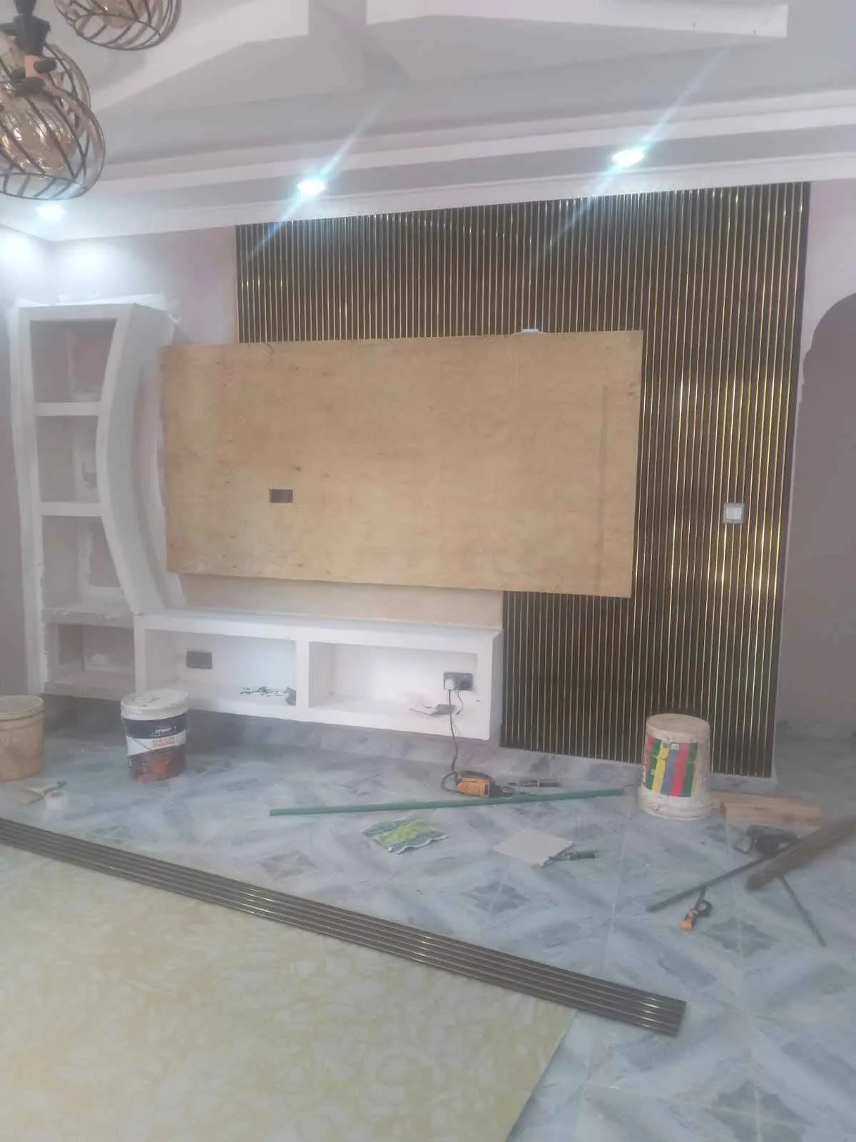 TV wall mid-build with plywood backing and fluted panels