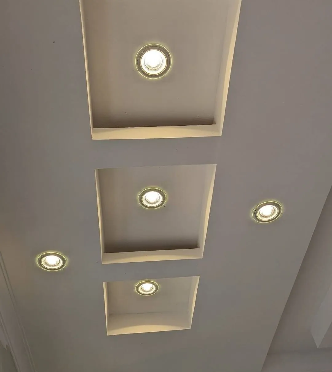 Coffered gypsum ceiling recesses with cove lighting