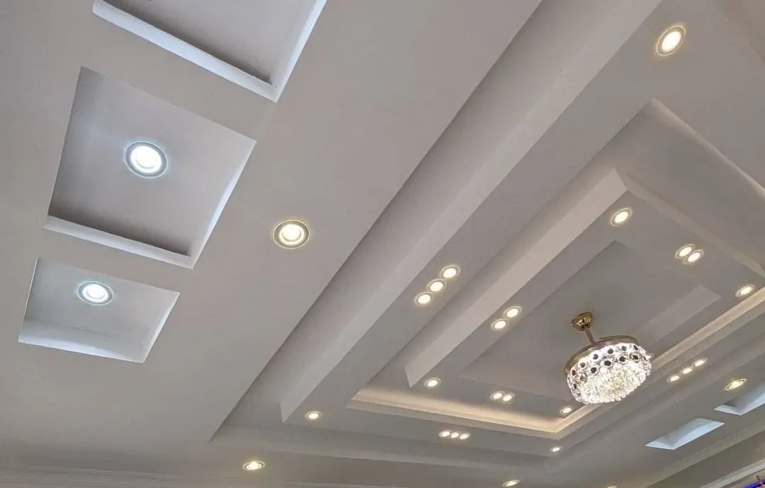 Tray ceiling detail with spotlights and central chandelier