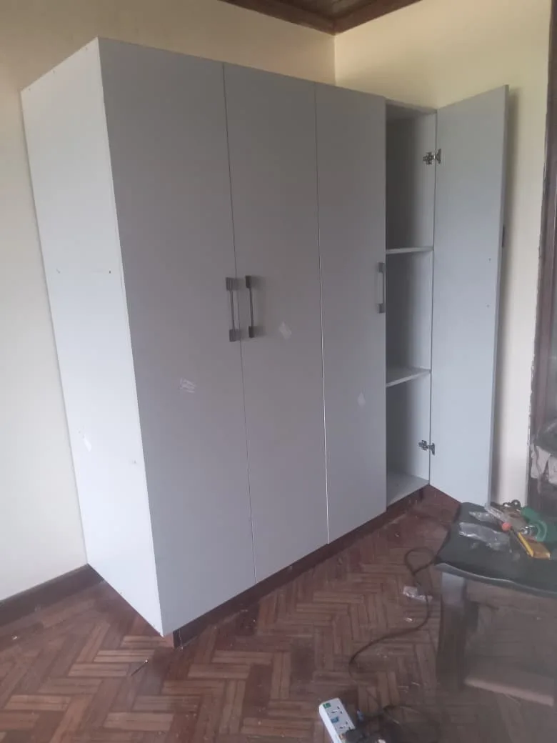 White wardrobe with mirrored section in a bedroom