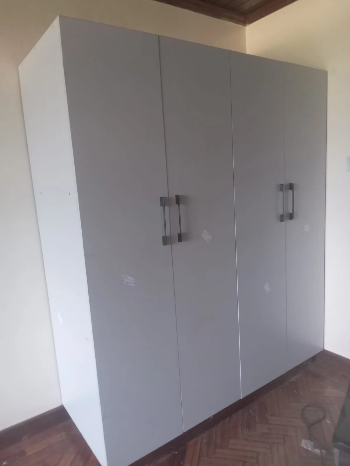 Grey wardrobe fitted into a bedroom corner