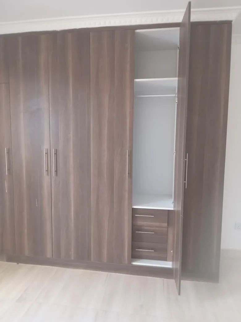 After: wood-grain wardrobe with open compartment showing shelving and drawers